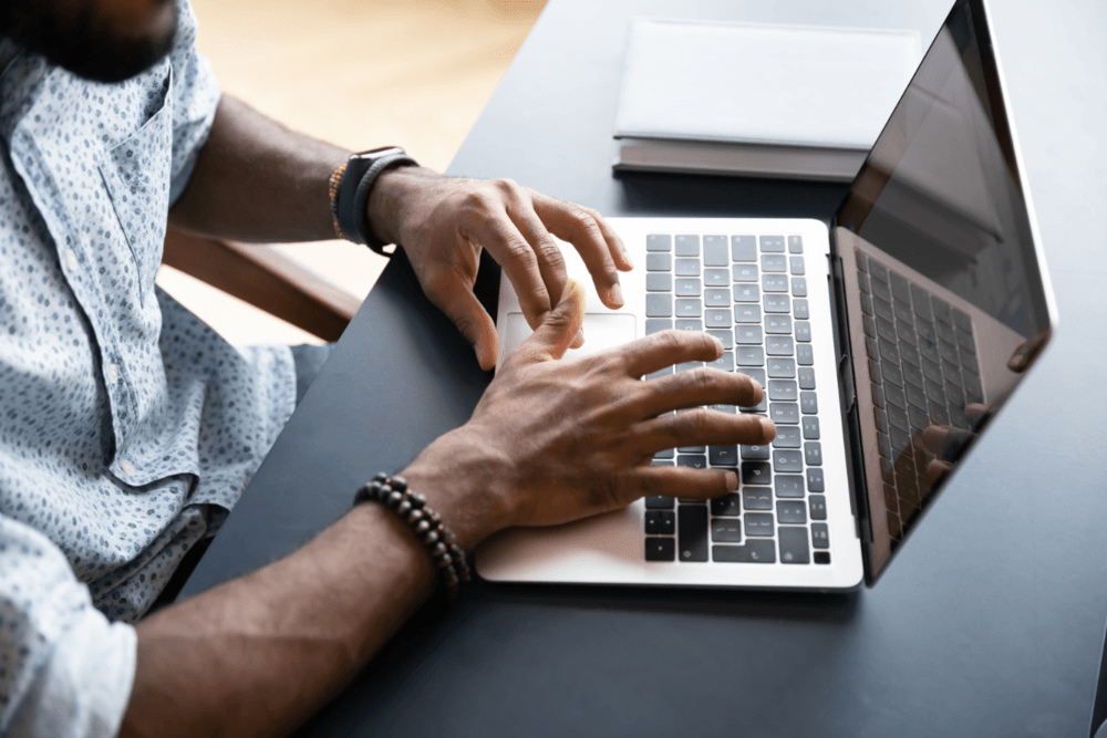 Hands on a laptop keyboard