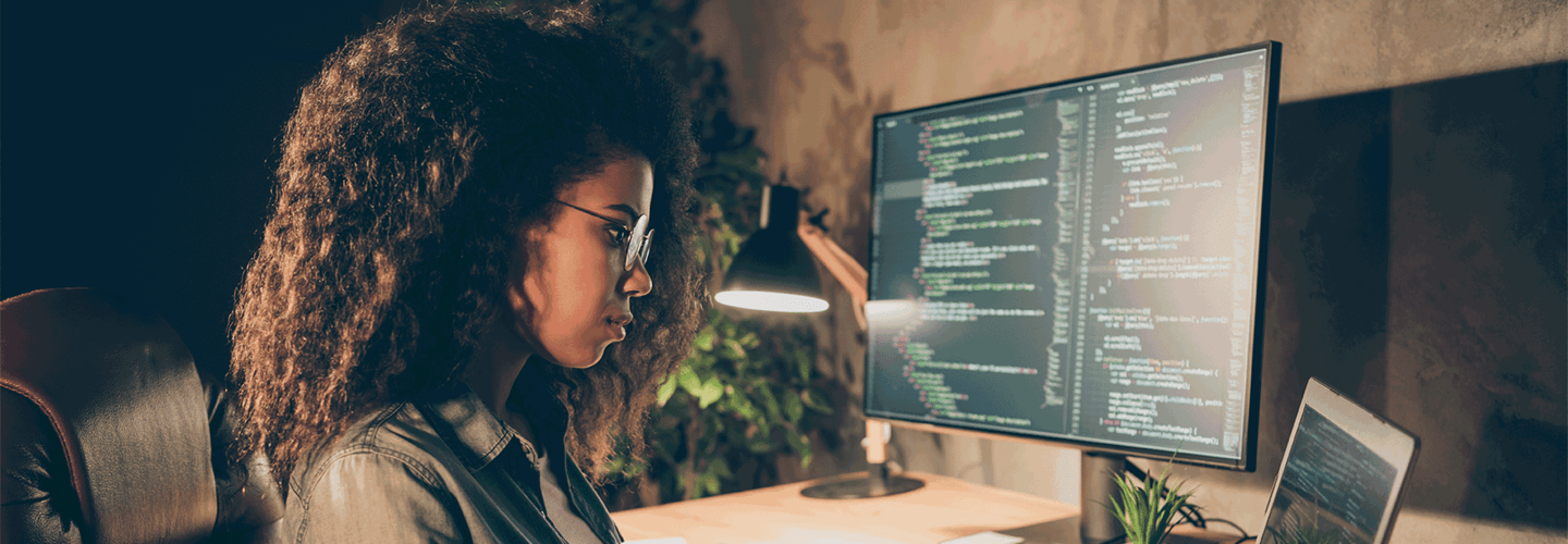 A woman looking at a computer screen