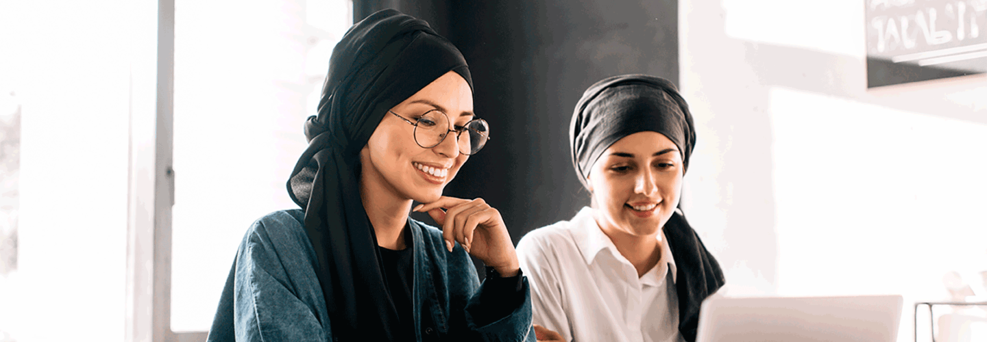 Two women looking at a laptop screen