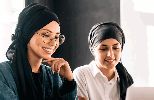 Two women looking at a laptop screen