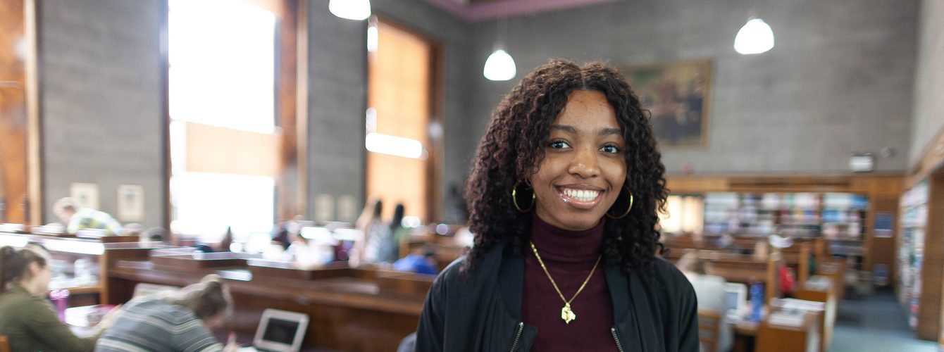 Student smiling in library