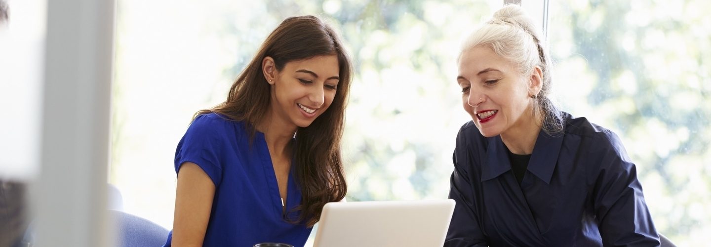 Two people looking at a laptop