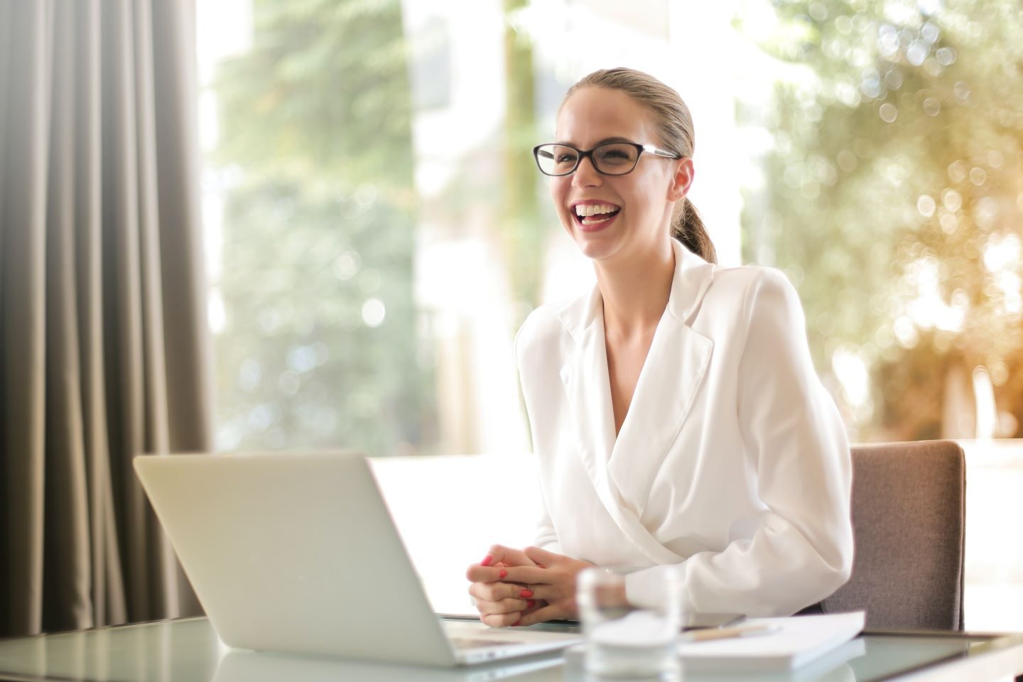 Person smiling at a laptop