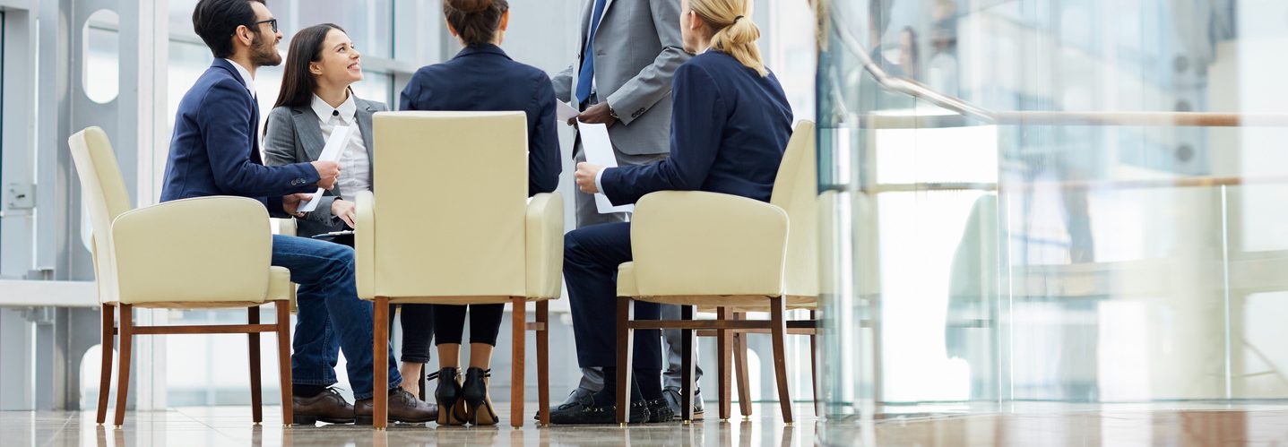 People wearing business suits having a discussion