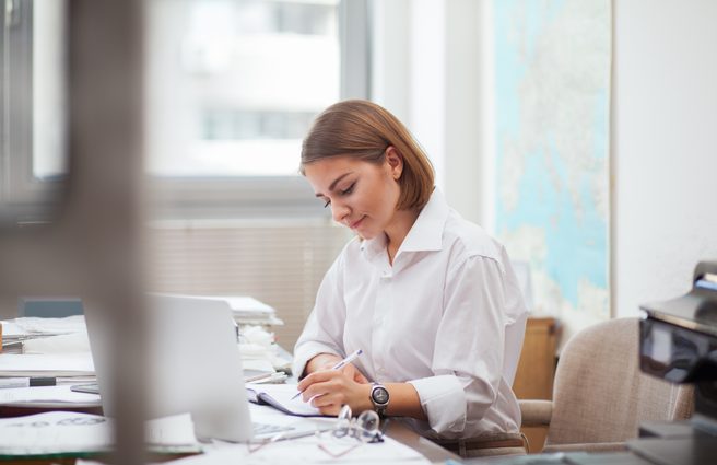 Young woman working on laptop at office