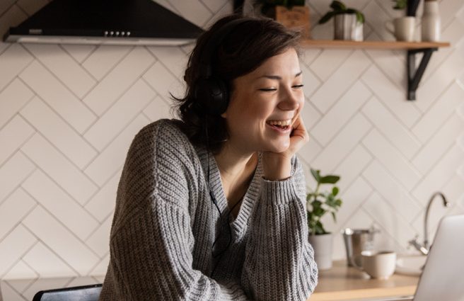 Woman looking at laptop in kitchen